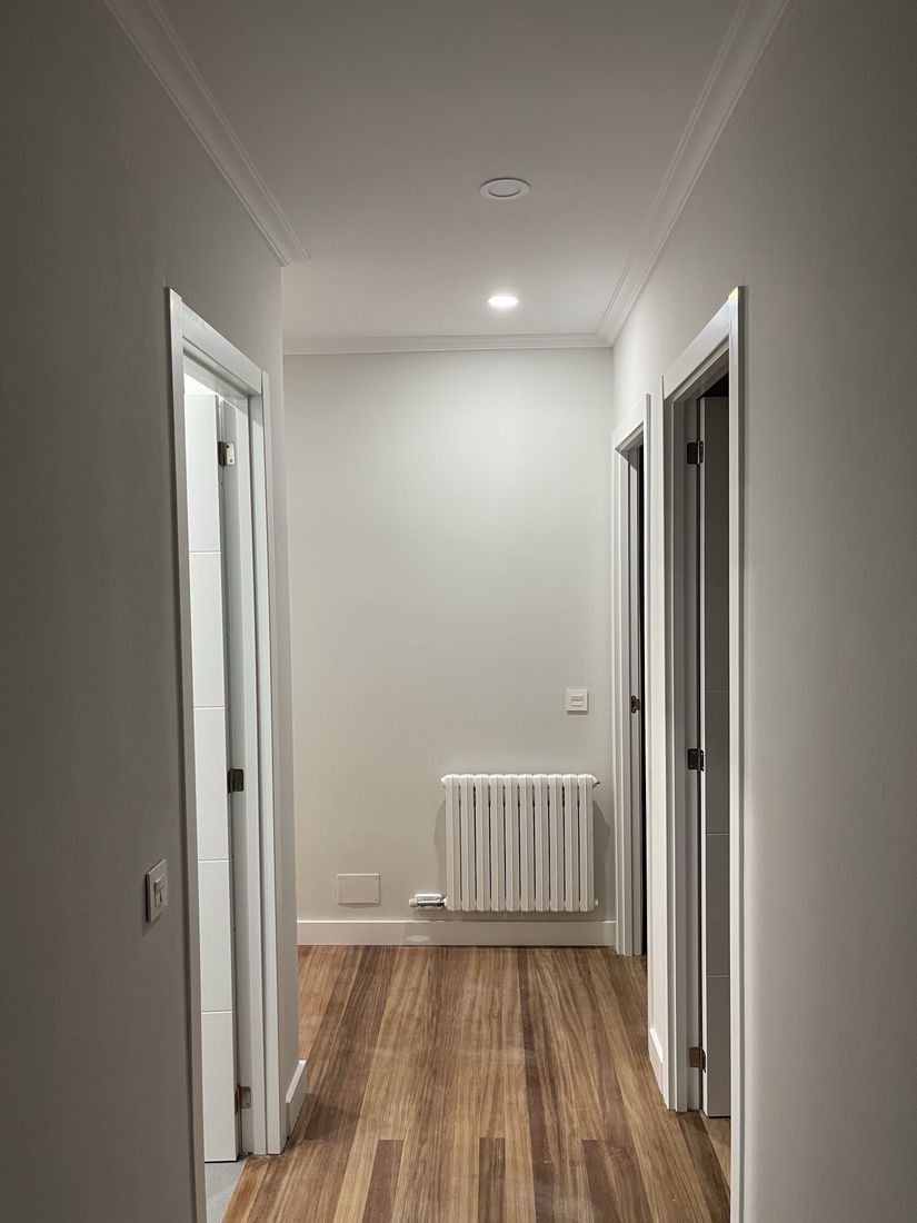 Hallway with crown molding, new door casings and recessed light